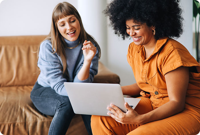 two professionals using a laptop