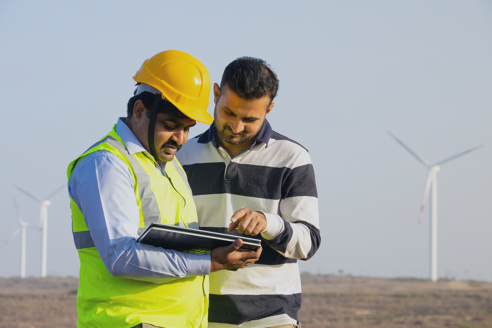 Field engineers reviewing work tablet